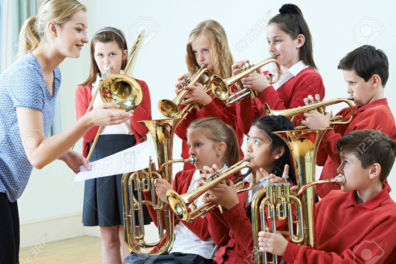 Group Of Students Playing In School Orchestra Together - 68382916 Group Of Students Playing In School Orchestra Together - 68382916