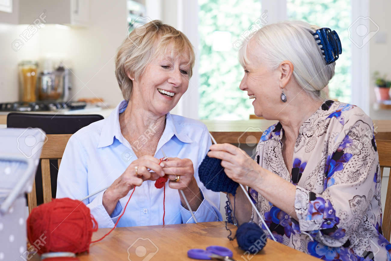Two Senior Female Friends Knitting At Home Together - 78664224 Two Senior Female Friends Knitting At Home Together - 78664224
