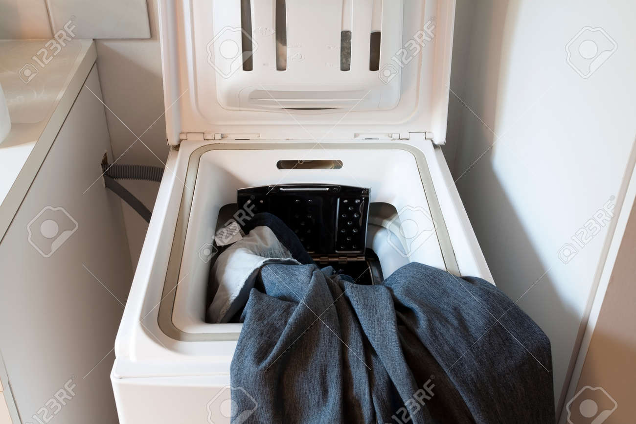 Laundry machine with open hatch and jeans - 50104951 Laundry machine with open hatch and jeans - 50104951