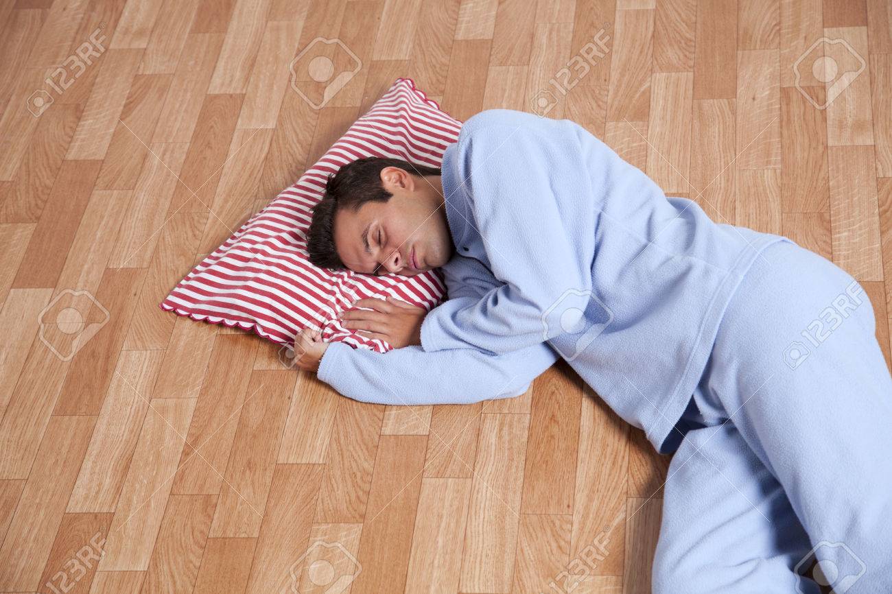 Young Man Dress With Nightclothes Sleeping On The Floor Isolated