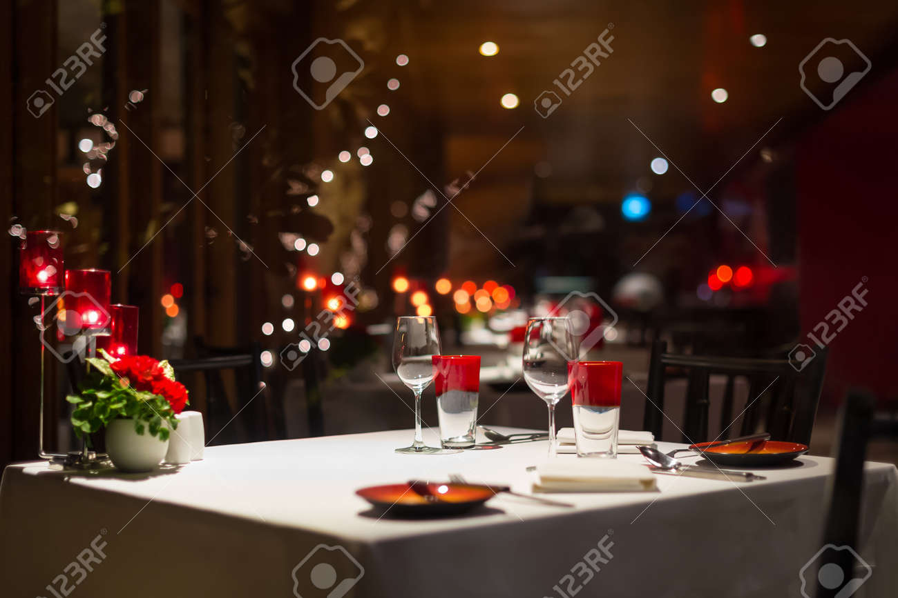 romantic dinner setup, red decoration with candle light in a romantic dinner setup, red decoration with candle light in a