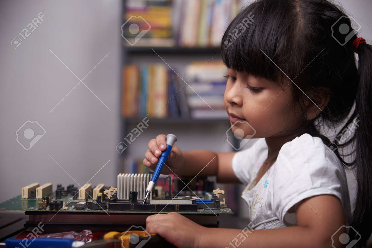 Little cute girl playing with broken computer part, kids creativity study at home during pandemic - 168492745 Little cute girl playing with broken computer part, kids creativity study at home during pandemic - 168492745