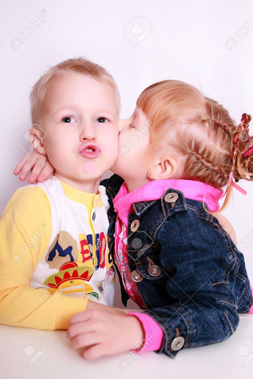 stock photo two small children in dressing gownes kiss the boy with the girl - Pics Of Small Children stock photo two small children in dressing gownes kiss the boy with the girl - Pics Of Small Children