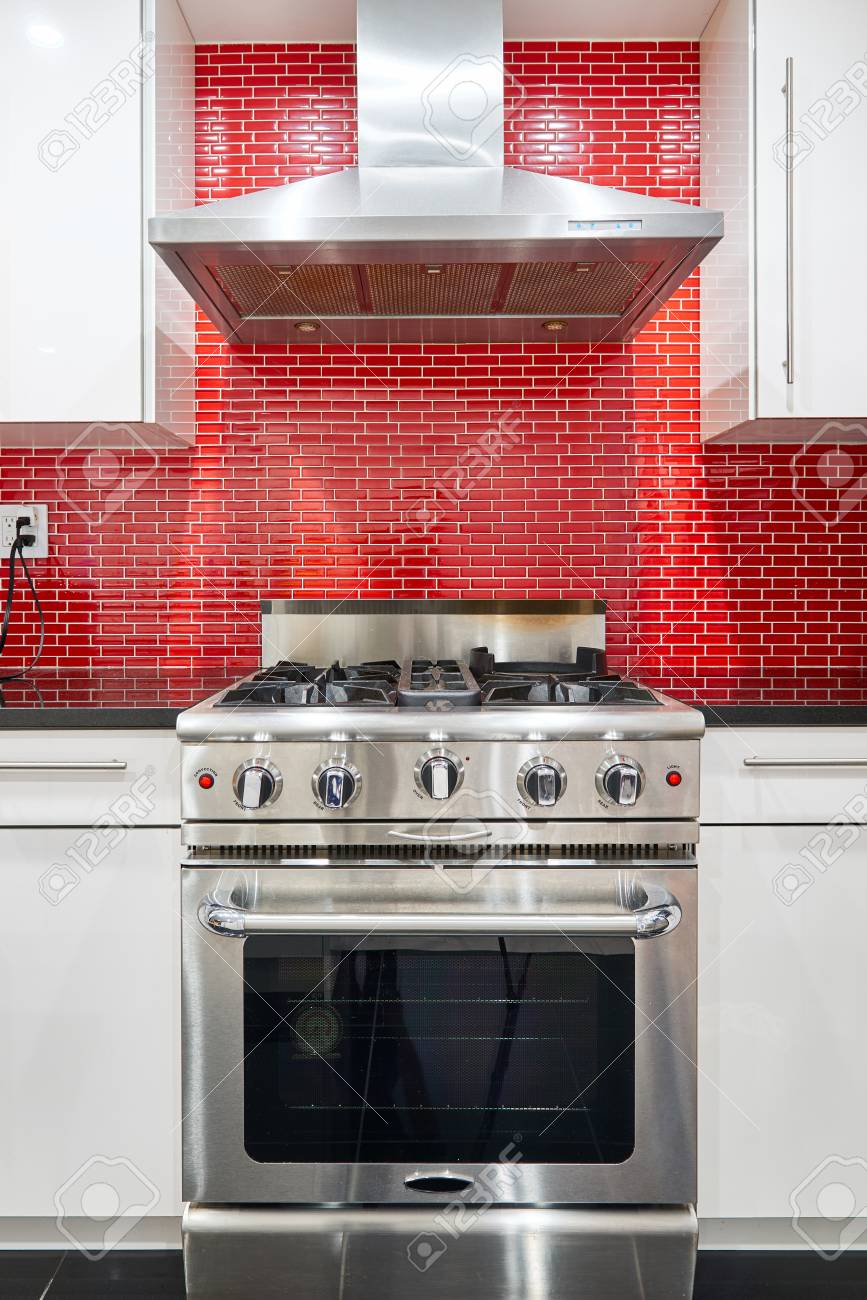 Modern Designed Kitchen With White Cabinets Red Back Splash