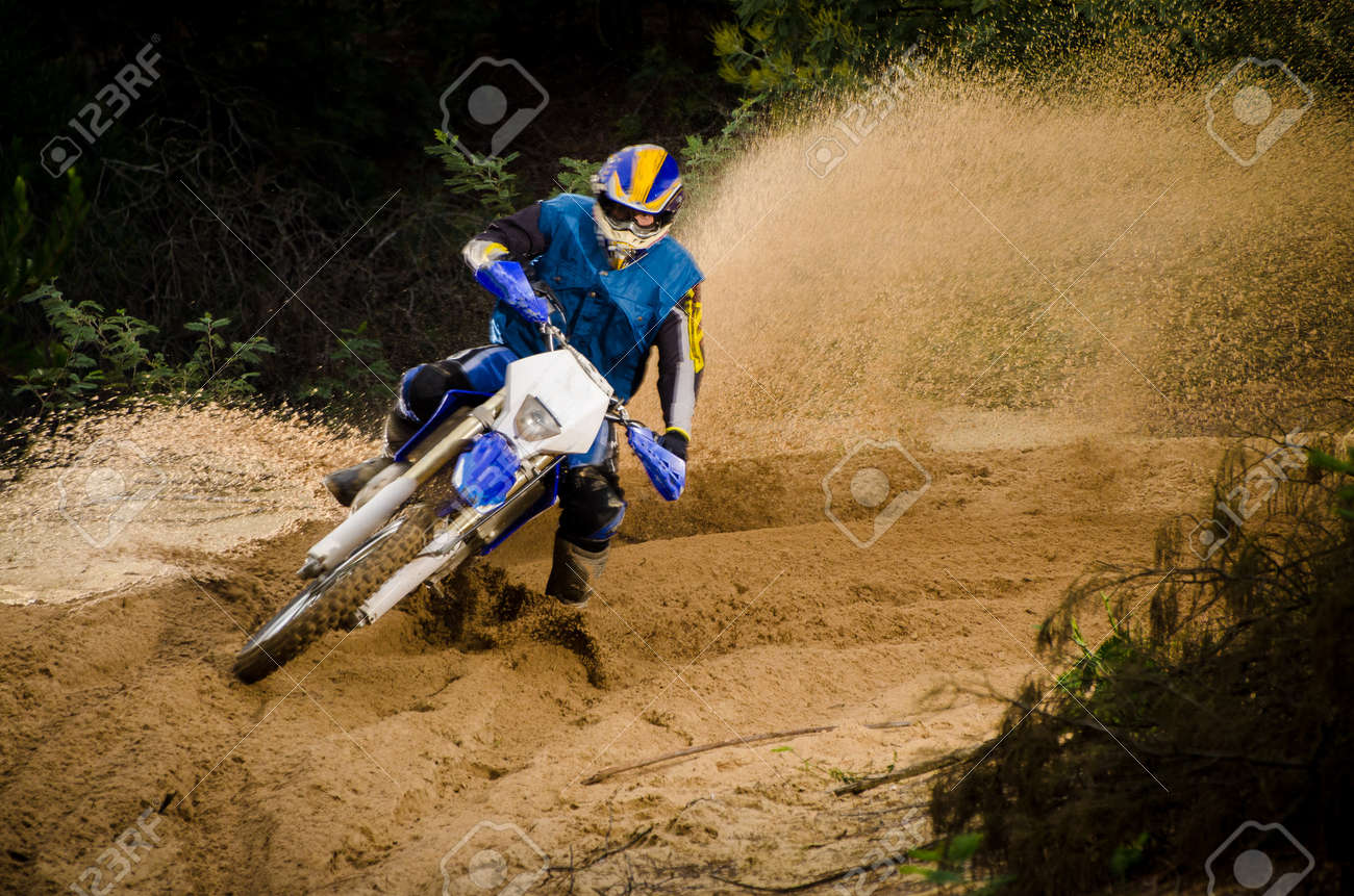 Enduro bike rider on action. Turn on sand terrain. - 16711248 Enduro bike rider on action. Turn on sand terrain. - 16711248