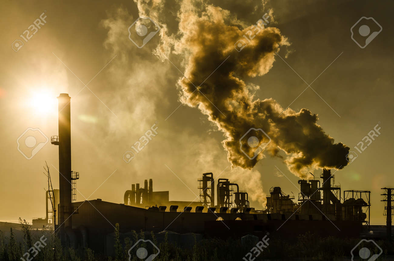 Air pollution coming from factory smoke stacks over sunset. Global concept earth preserving. Halt global warming - 20823150 Air pollution coming from factory smoke stacks over sunset. Global concept earth preserving. Halt global warming - 20823150