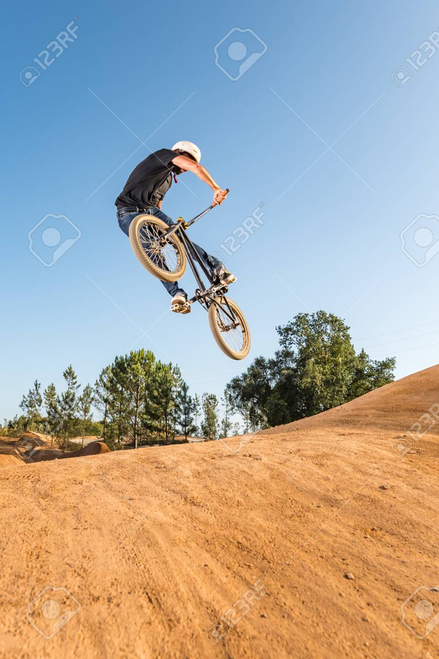 Bmx Rider Performing A Look Back At A Dirt Trail Park Stock Photo Picture And Royalty Free Image Image