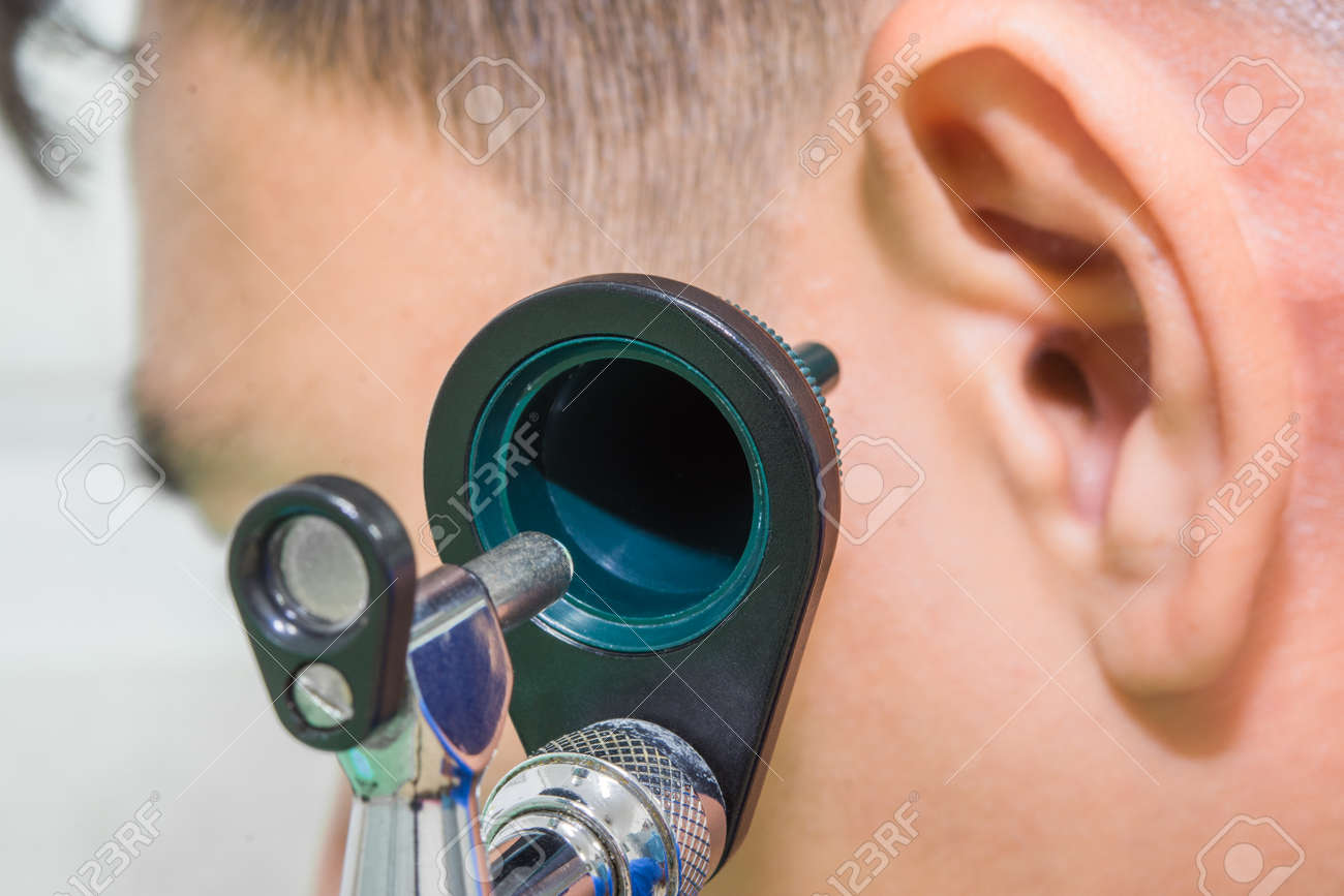 otoscope on the left ear of a man patient concept healthcare - 73770018 otoscope on the left ear of a man patient concept healthcare - 73770018