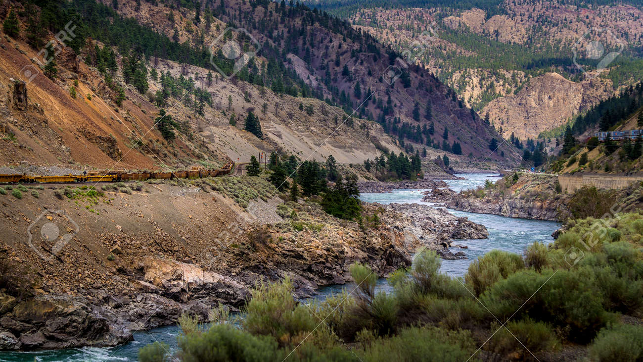Railway and the Trans Canada Highway follow the Thompson River with its many rapids flowing through the Canyon in the Coastal Mountain Ranges of British Columbia, Canada - 156120870 Railway and the Trans Canada Highway follow the Thompson River with its many rapids flowing through the Canyon in the Coastal Mountain Ranges of British Columbia, Canada - 156120870