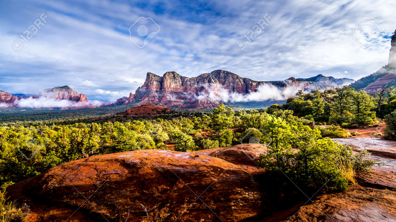 Low Cloud hanging around the Red Rocks of Munds Mountain and Twin Buttes after a heavy rainfall near the town of Sedona in northern Arizona in Coconino National Forest, USA - 159817645 Low Cloud hanging around the Red Rocks of Munds Mountain and Twin Buttes after a heavy rainfall near the town of Sedona in northern Arizona in Coconino National Forest, USA - 159817645