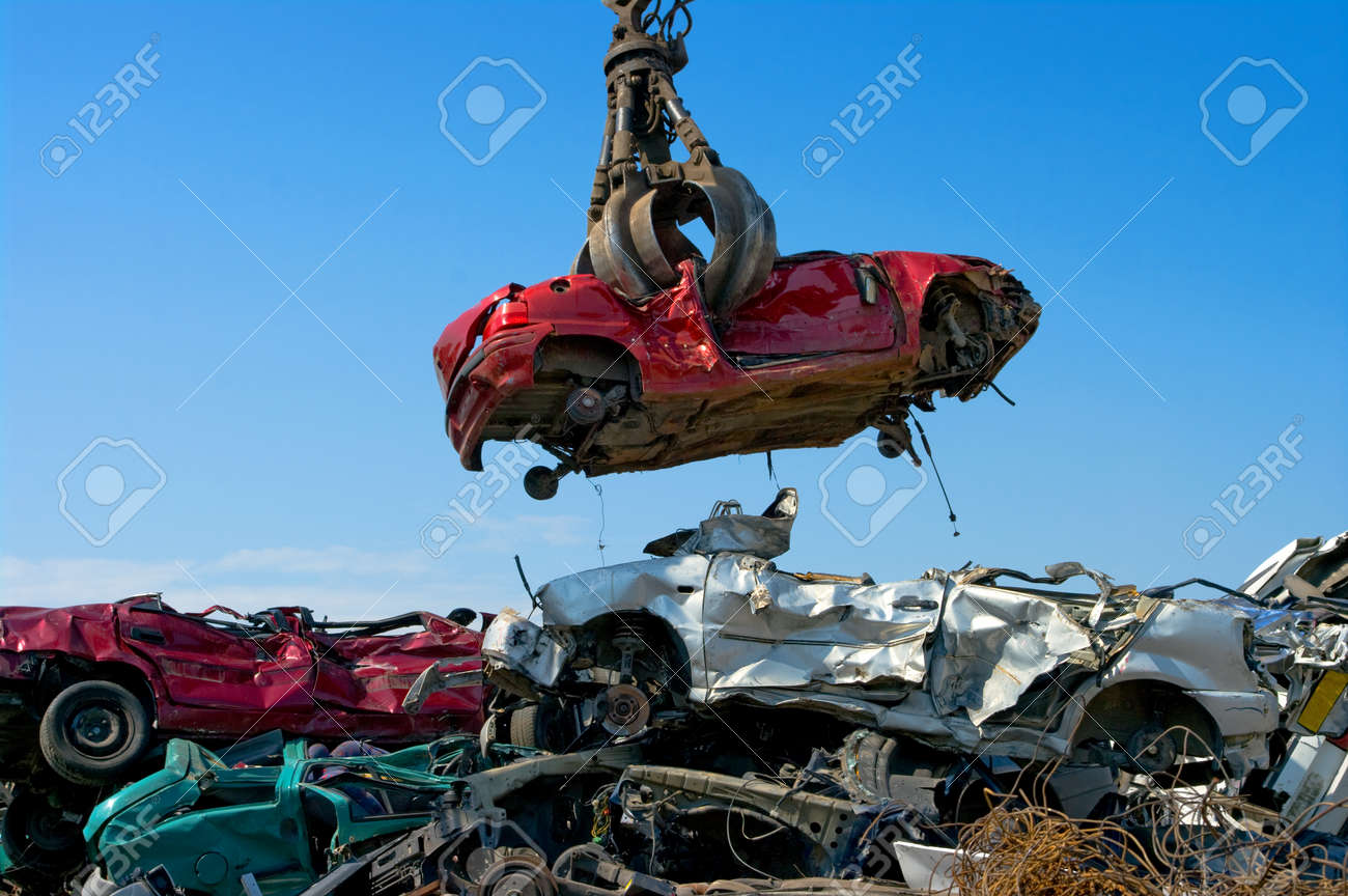 Crane picking up a car in a junkyard - 24981826 Crane picking up a car in a junkyard - 24981826