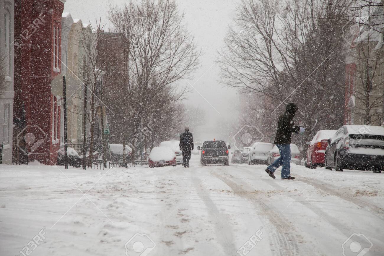 Pedestrians walking the streets of Georgetown in Washington DC under snow storm - 26787992 Pedestrians walking the streets of Georgetown in Washington DC under snow storm - 26787992