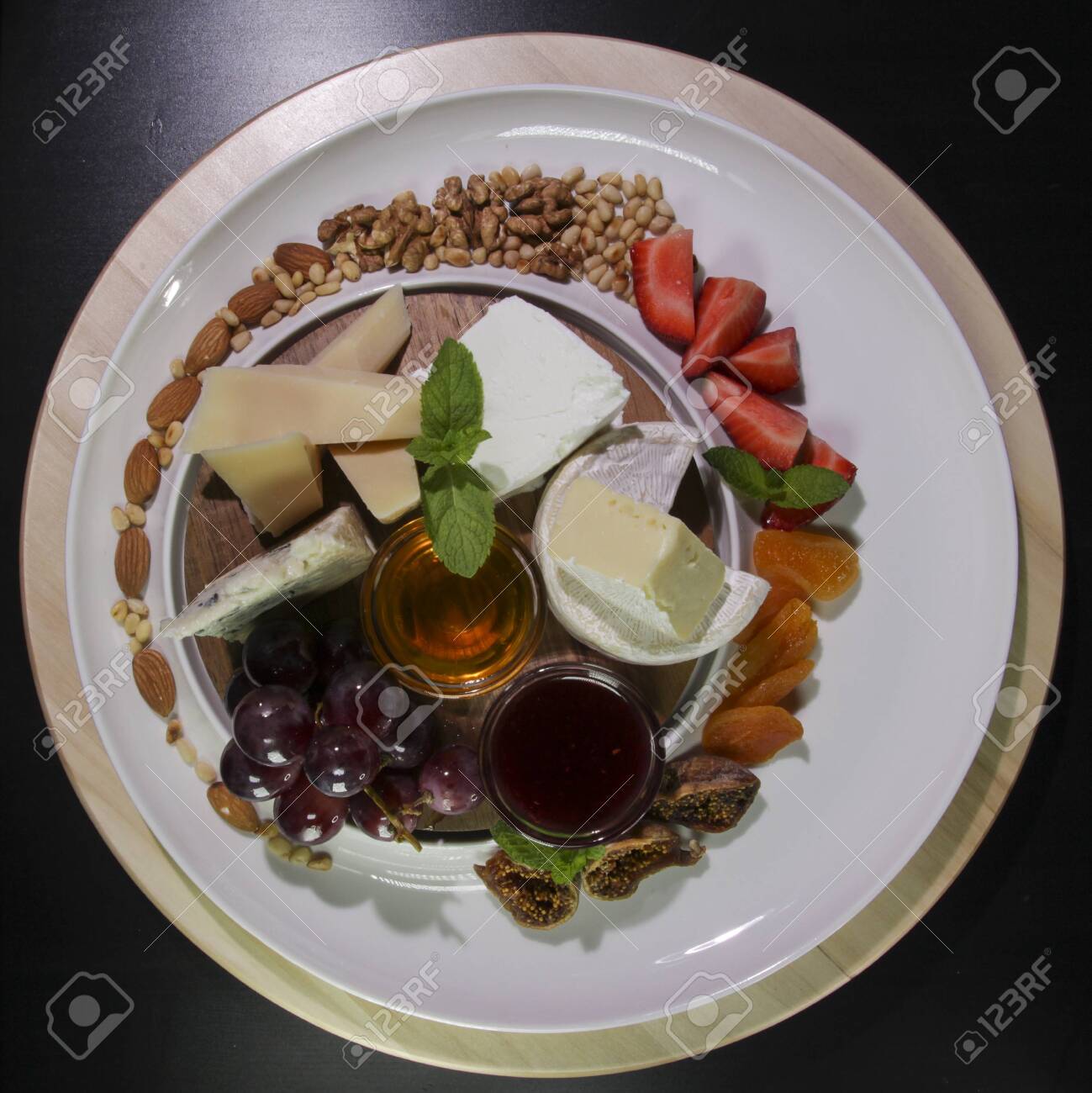 Cheese plate.Isolated on a black background.View from above. - 142255471 Cheese plate.Isolated on a black background.View from above. - 142255471
