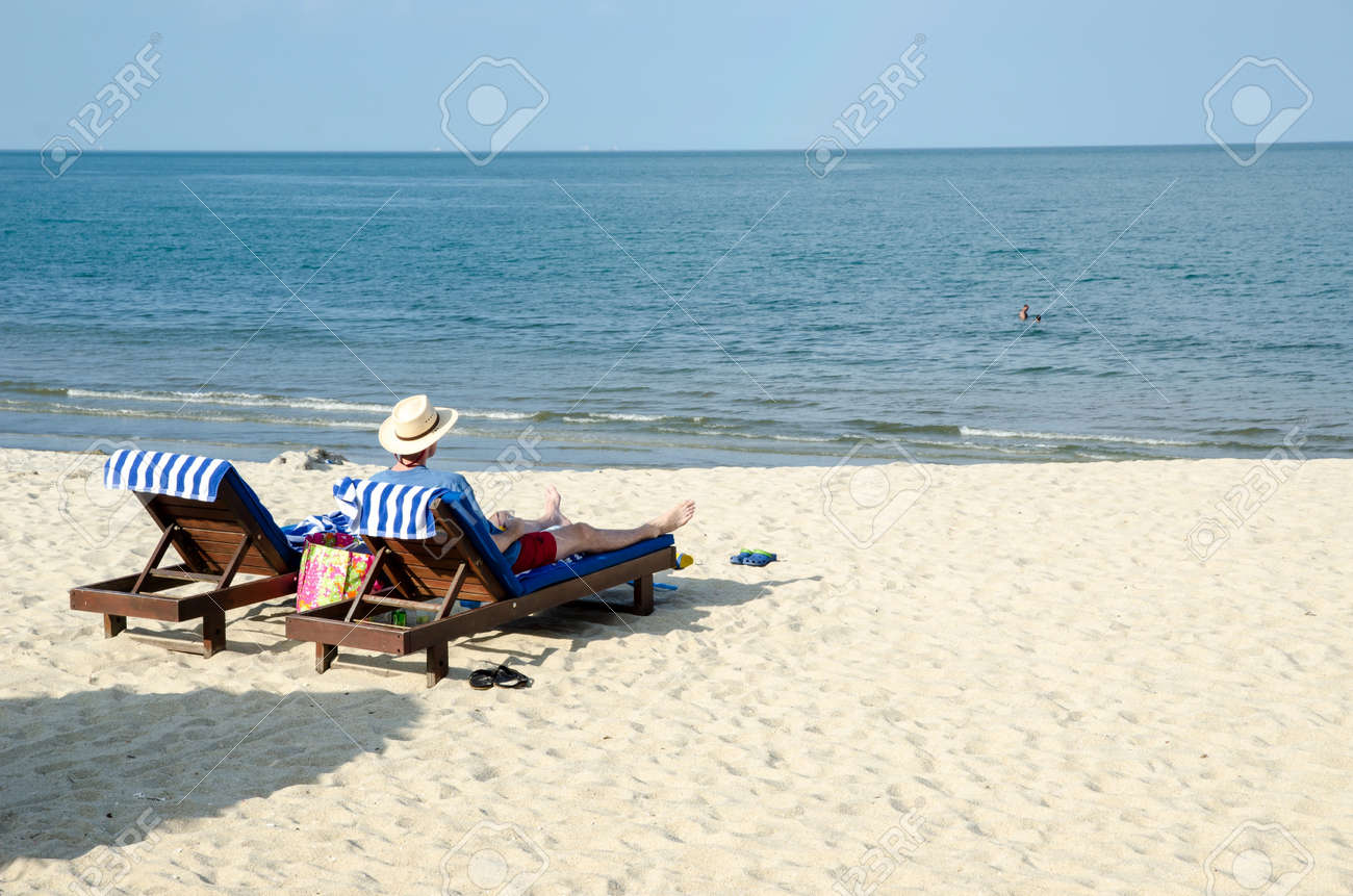 guy relaxing at the beach stock photo picture and royalty free