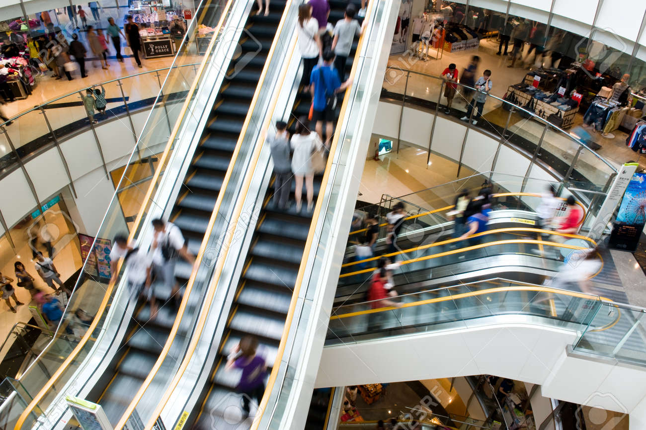 People In Motion In Escalators At The Modern Shopping Mall Stock - People In Motion In Escalators At The Modern Shopping Mall Stock Photo people in motion in escalators at the modern shopping mall stock - people in motion in escalators at the modern shopping mall stock photo