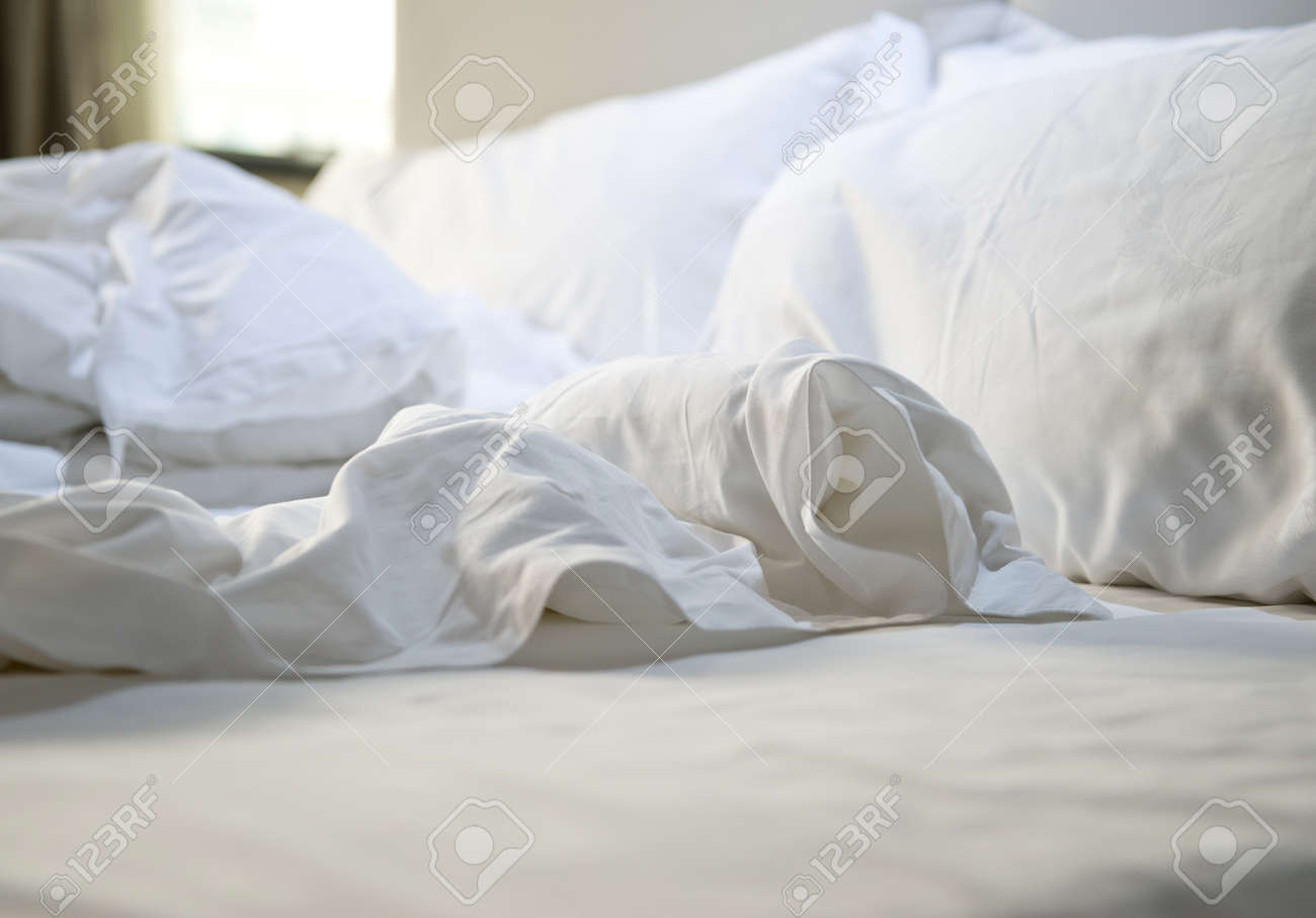 close up of messy bedding sheets and pillow stock photo picture and