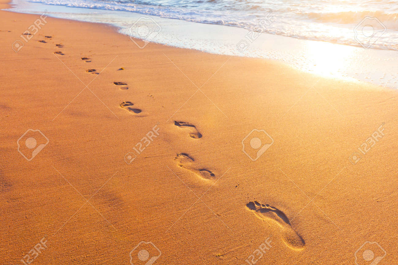 beach, wave and footsteps at sunset time - 18516188 beach, wave and footsteps at sunset time - 18516188