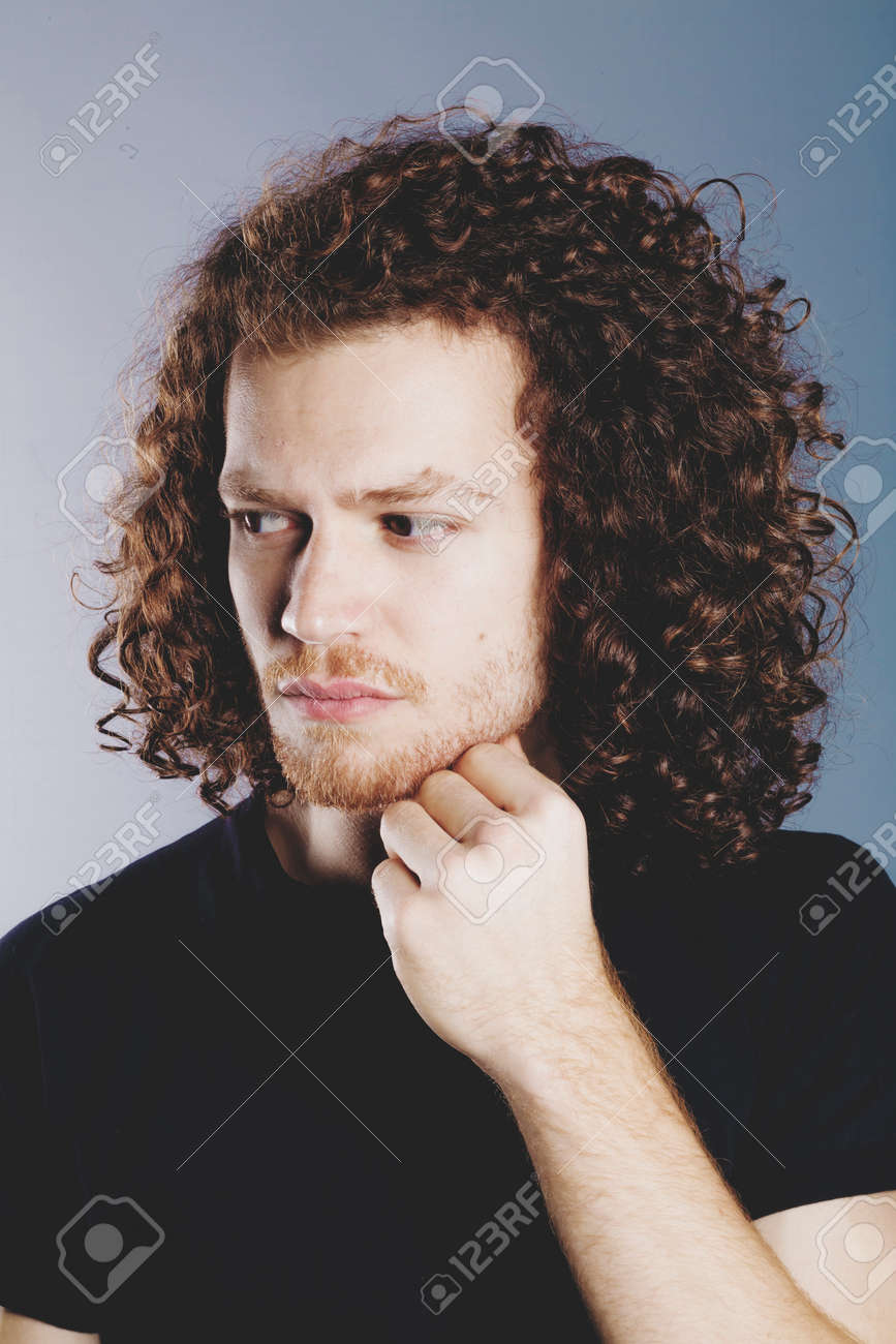 Attractive Young Man With Long Ginger Curly Hair Studio Portrait