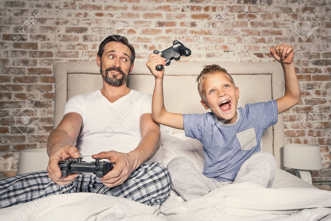 dad and son playing video games