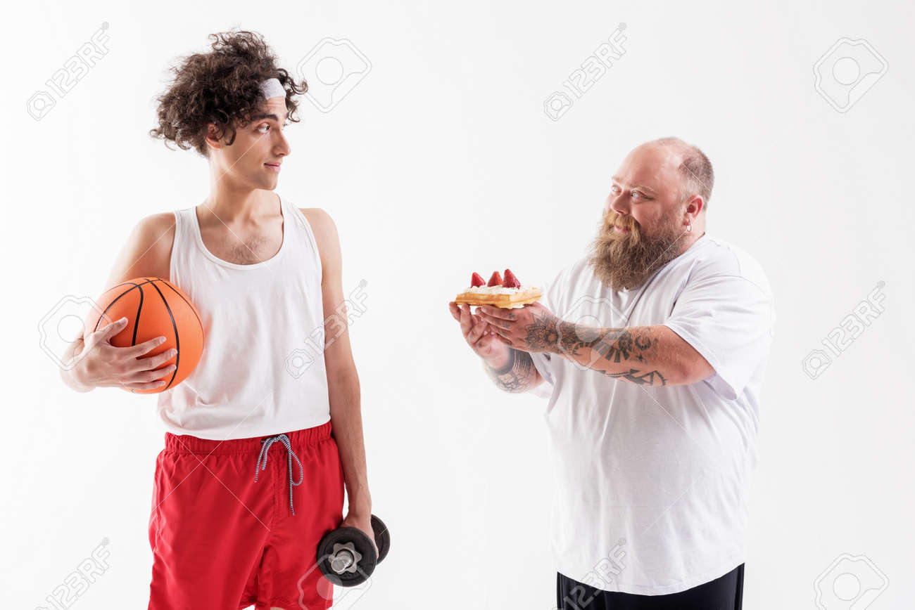 Thick guy seducing thin sportsman by cake - 80474979 Thick guy seducing thin sportsman by cake - 80474979