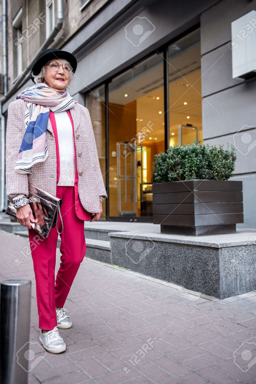 街を歩いてうれしそうなスタイリッシュな年配の女性 の写真素材 画像素材 Image