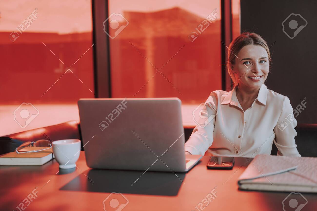 Joyful young woman working on laptop in office - 137250043 Joyful young woman working on laptop in office - 137250043