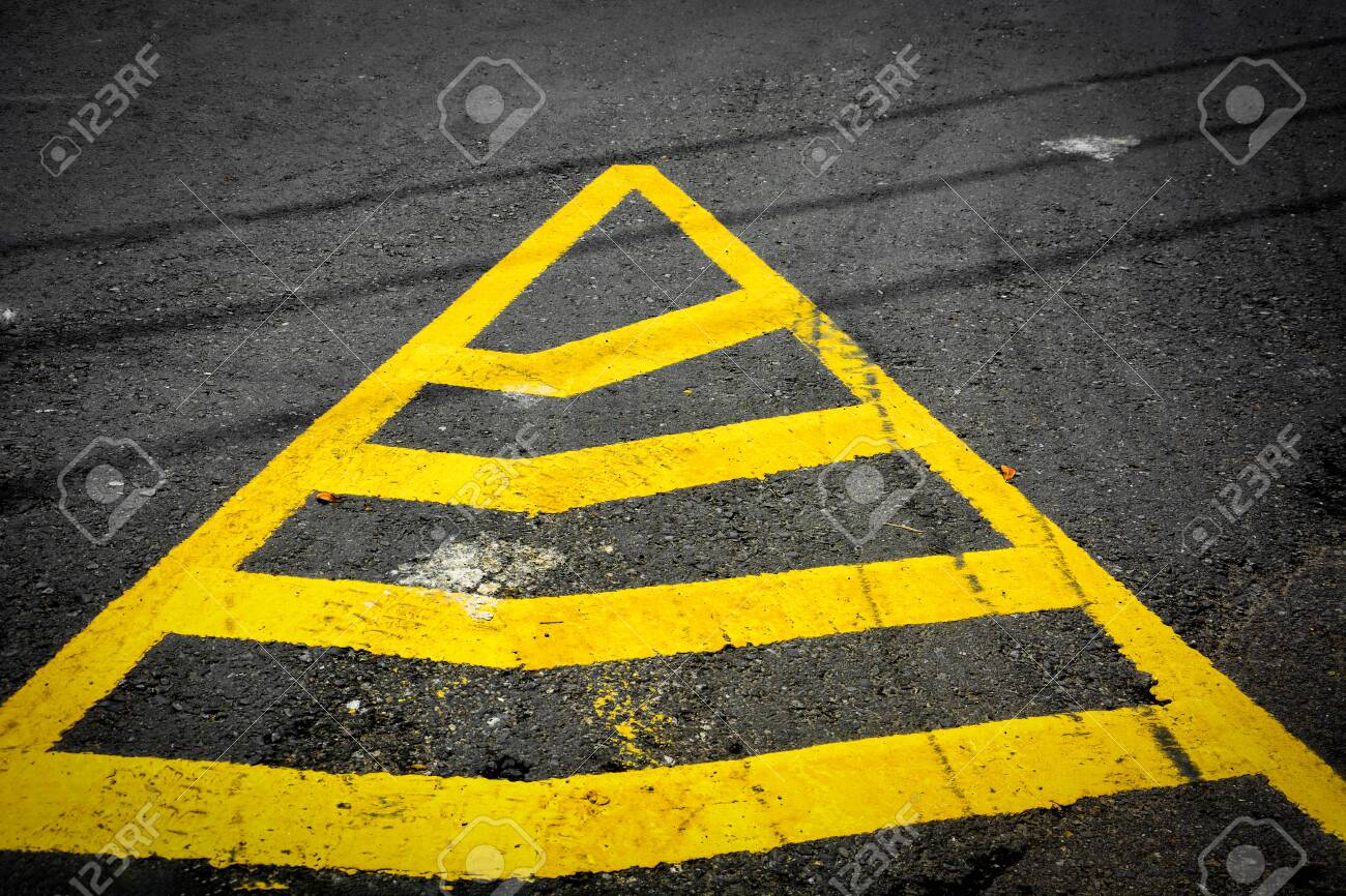 Yellow Triangle No Parking Lines Painted On Black Asphalt Road