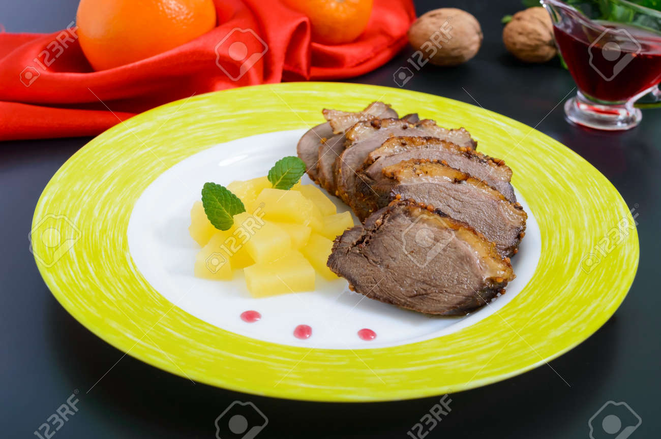 Duck Breast Magret With Pieces Of Pineapple On A Ceramic Plate