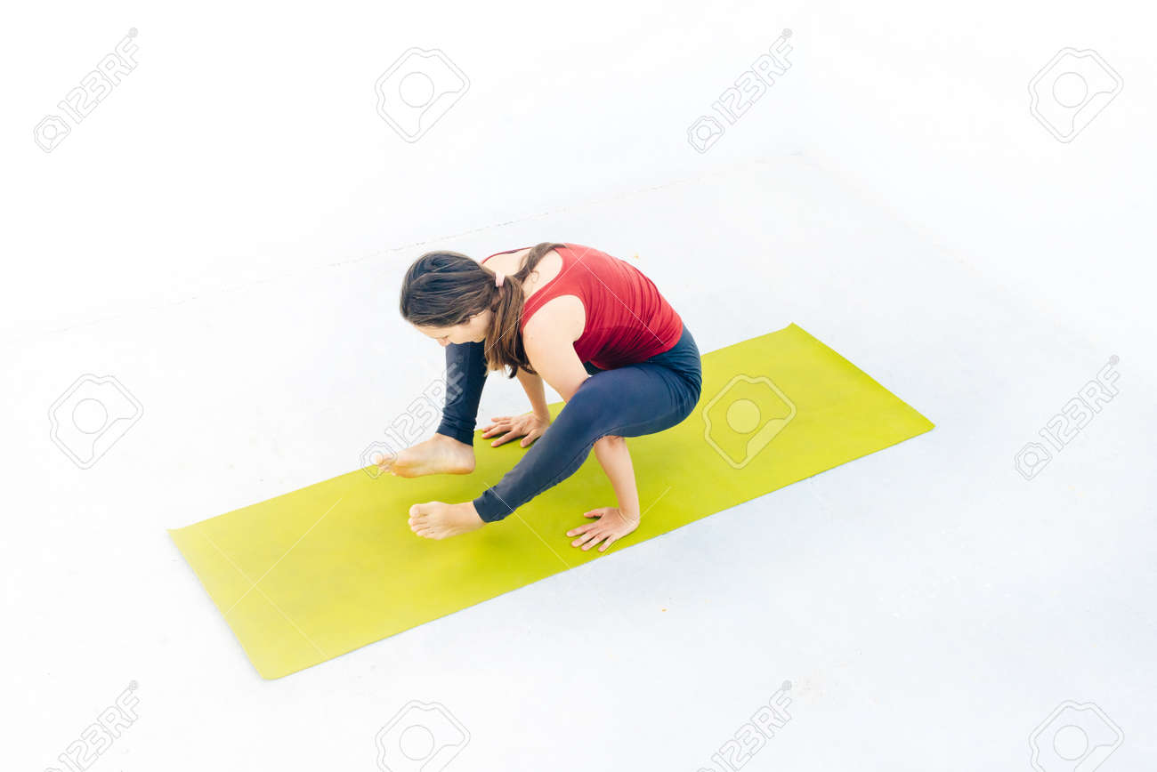 Side view portrait of beautiful young woman doing yoga or pilates exercise. - 169580045 Side view portrait of beautiful young woman doing yoga or pilates exercise. - 169580045