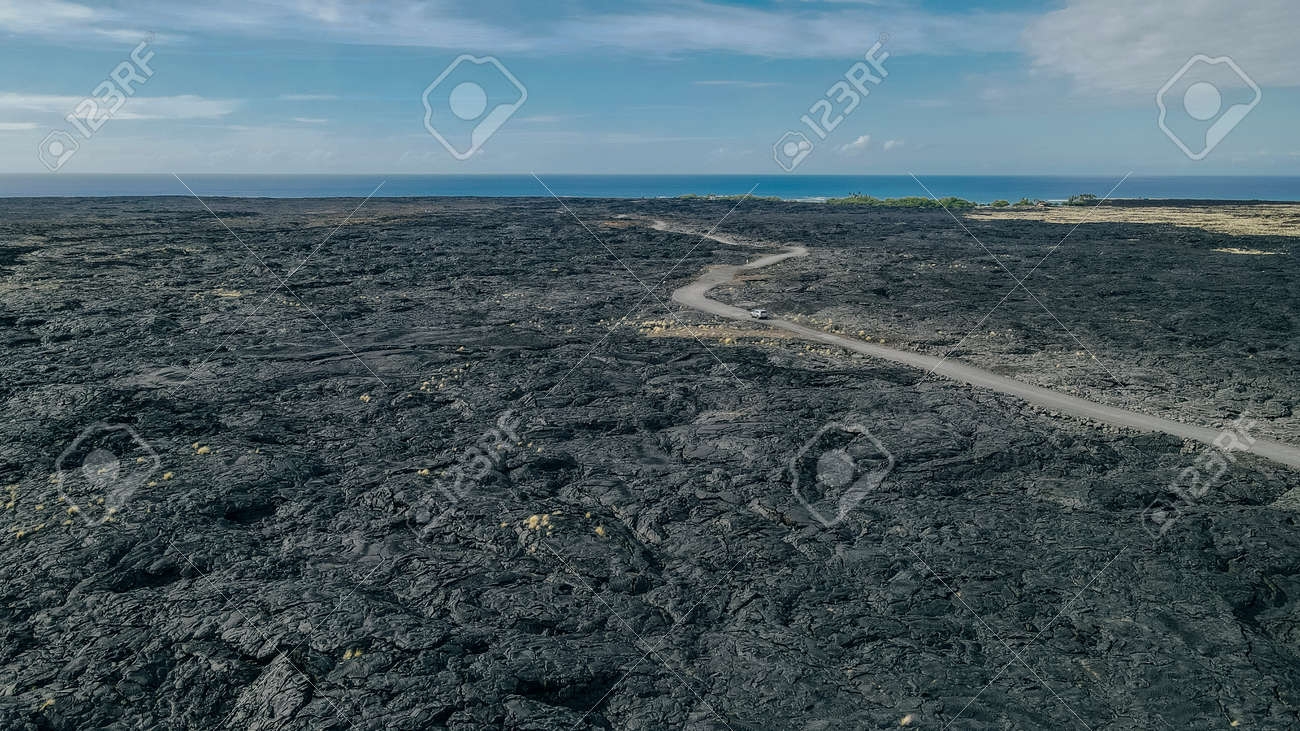 Chain of Craters Road in Hawaii Volcanoes National Park is vivid with blue ocean, waves and black sea cliffs. Cliffs were formed when Mauna Ulu exploded liquid lava. - 170120304 Chain of Craters Road in Hawaii Volcanoes National Park is vivid with blue ocean, waves and black sea cliffs. Cliffs were formed when Mauna Ulu exploded liquid lava. - 170120304