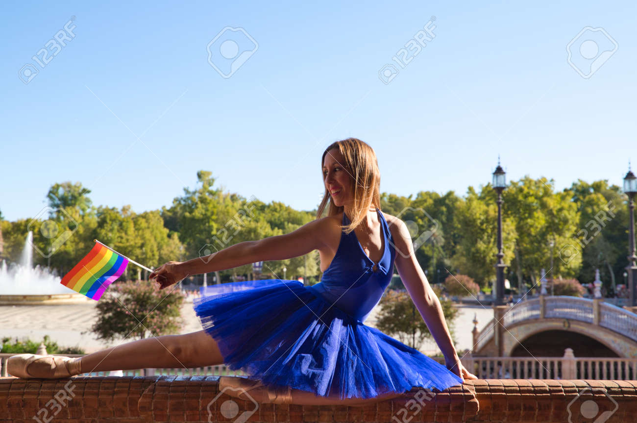 Classical Ballet Dancer And Lesbian Leaning On A Railing In A Park. Holding  The Gay Pride Flag In Her Hand. Concept Of Homosexuality And Ballet Stock  Photo, Picture and Royalty Free Image.