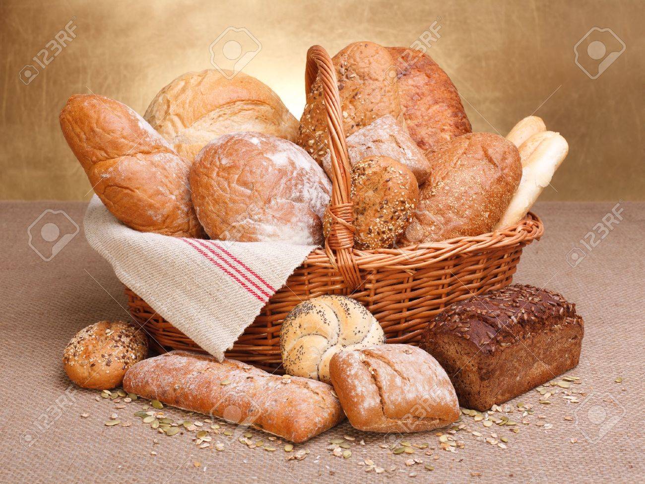 Various breads in basket on canvas tablecloth - 16059613 Various breads in basket on canvas tablecloth - 16059613