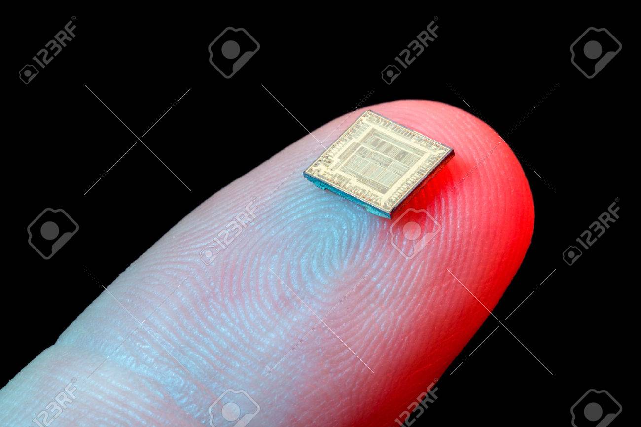 Silicon micro chip on human finger's tip - 35631152 Silicon micro chip on human finger's tip - 35631152