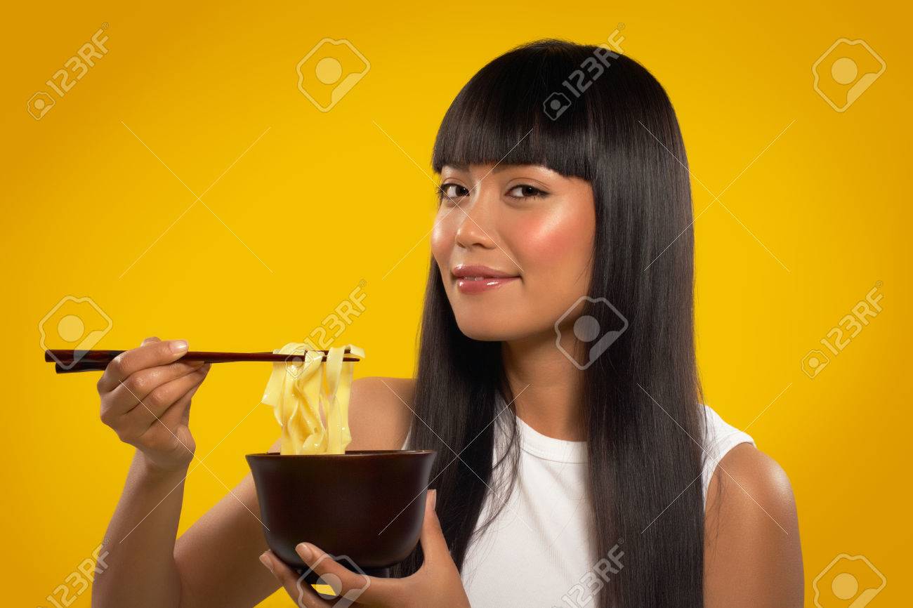 Cheerful Asian girl with noodles and chopsticks. - 38409440 Cheerful Asian girl with noodles and chopsticks. - 38409440