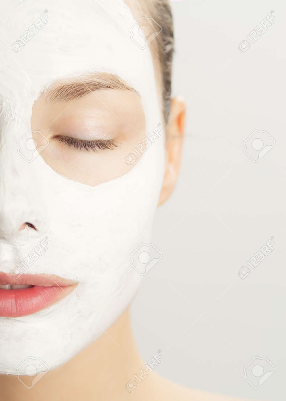 Closeup of beautiful young woman with white clay cosmetic mask. Skincare using masks. White clay clarifying facial mask. - 40763096 Closeup of beautiful young woman with white clay cosmetic mask. Skincare using masks. White clay clarifying facial mask. - 40763096