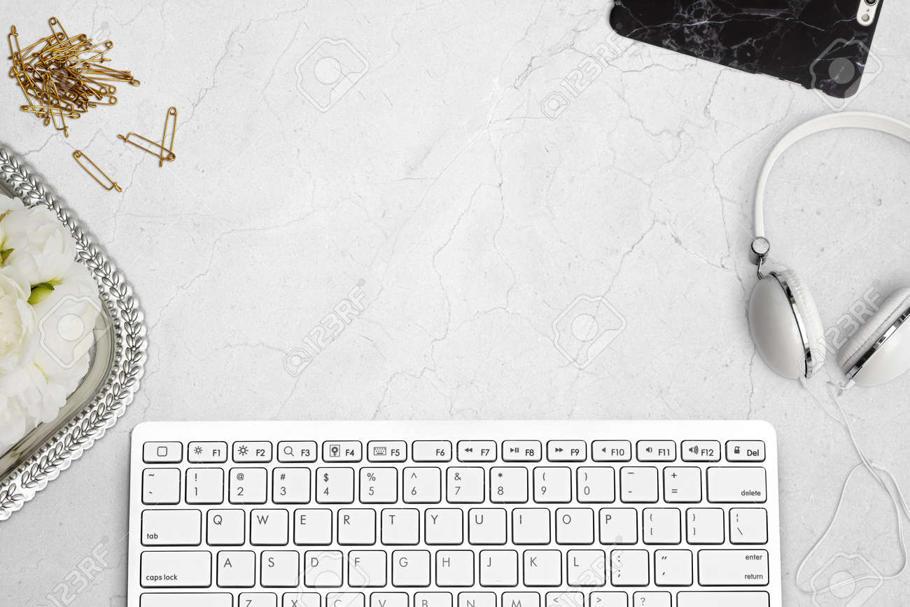 Elegant top view of desk with keyboard, mobile phone and headphones on marble. Styled stock top view mockup scene. - 59851575 Elegant top view of desk with keyboard, mobile phone and headphones on marble. Styled stock top view mockup scene. - 59851575