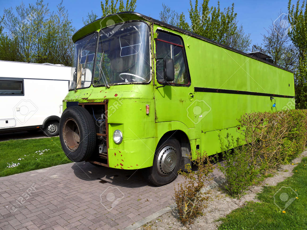Vintage Style Old Scrap Green Retro Camper On Camping Site Stock Photo Vintage Style Old Scrap Green Retro Camper On Camping Site Stock Photo