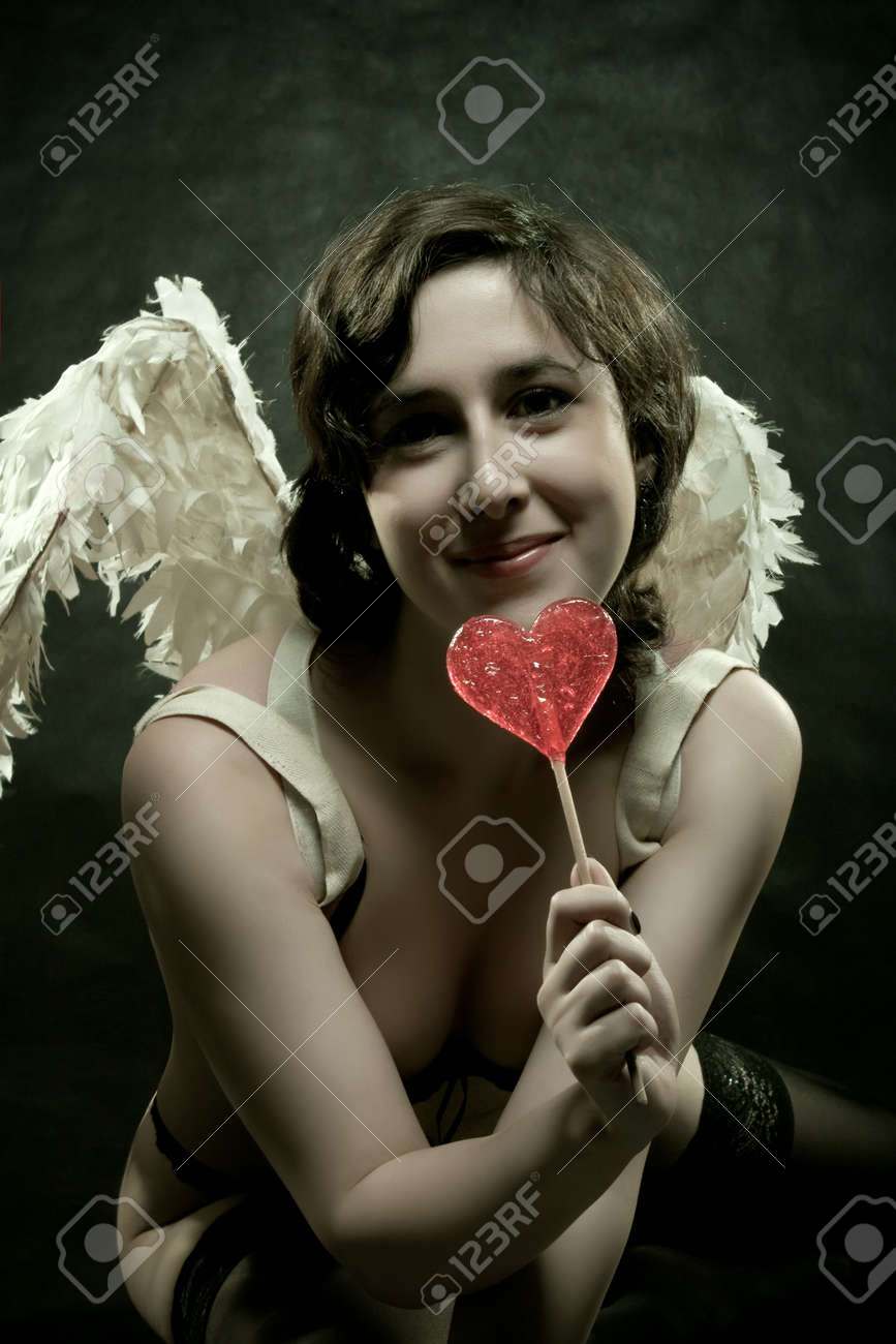 12163217-funny-angel-posing-with-lollipo