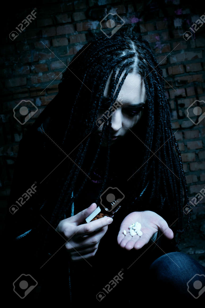 Sad Girl Posing In The Dark Room With Pills Stock Photo, Picture and  Royalty Free Image. Image 12386711.
