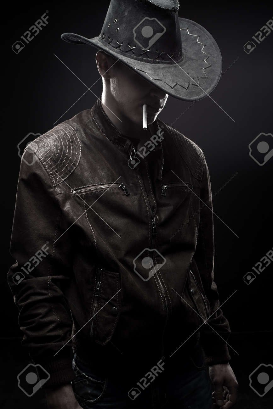 Cool Cowboy In Jacket With Cigarette Over Dark Background Stock Photo, Picture And Royalty Free Image. Image 17347152.