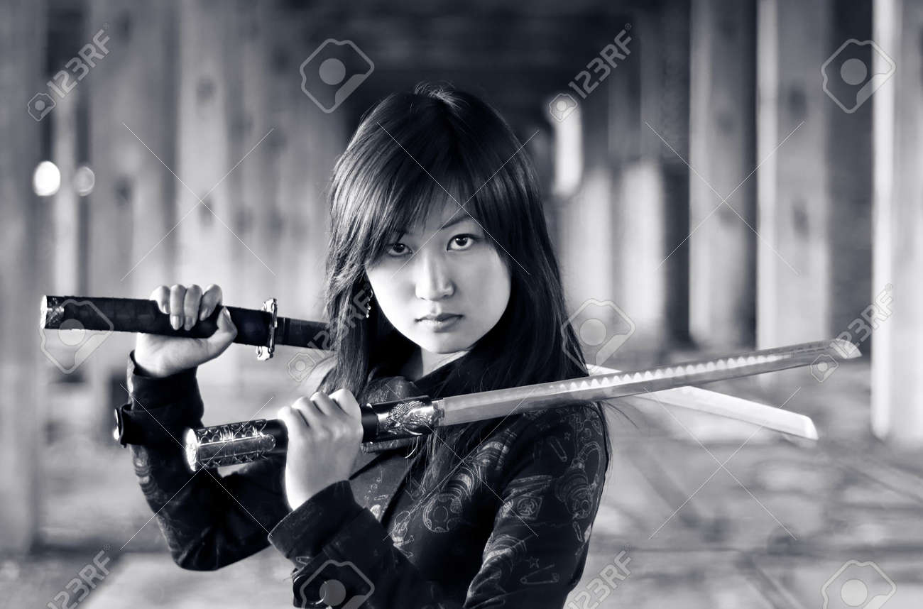 Dangerous asian girl with katana in ruins - 6675158. 