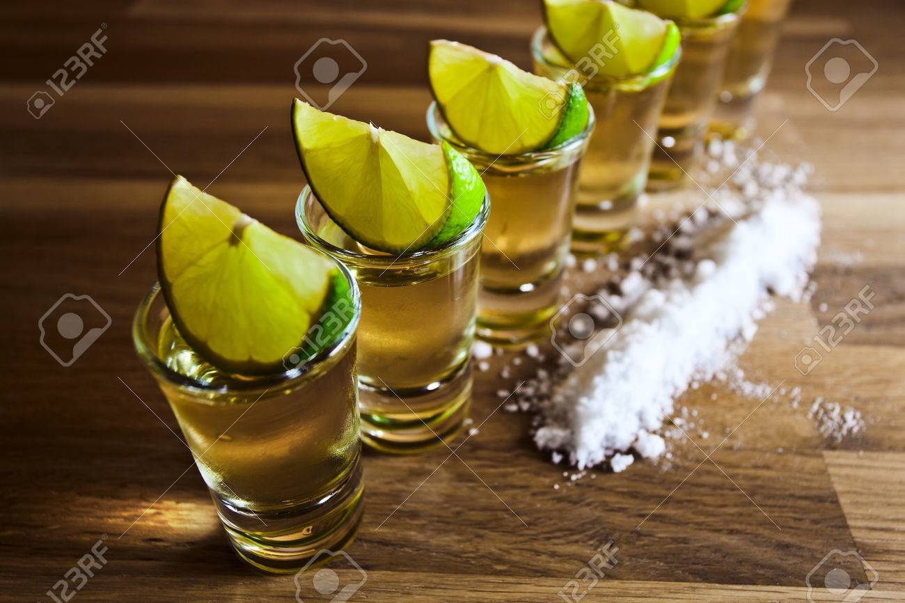 Tequila , Lime And Salt On Wooden Table Stock Photo, Picture And Royalty  Free Image. Image 23445886.