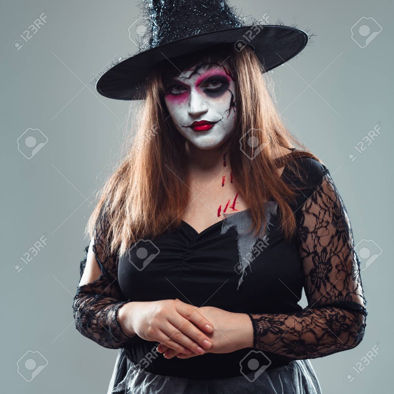 Gothic Young Woman In Witch Halloween Costume With Hat Standing Gothic Young Woman In Witch Halloween Costume With Hat Standing Over Gray Background