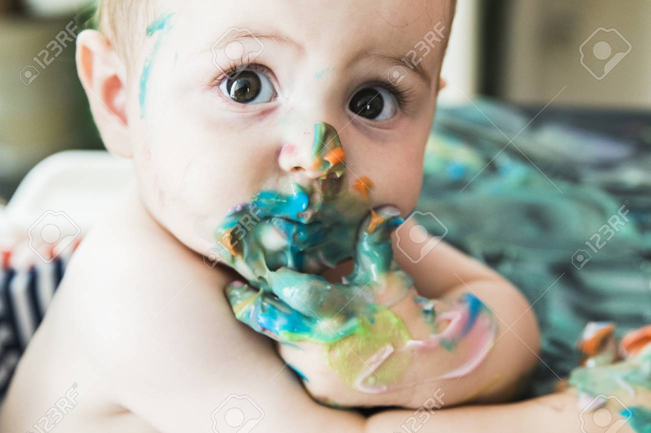 A Baby With A Face Smeared With Paint Stock Photo, Picture And Royalty Free Image. Image 97880050.