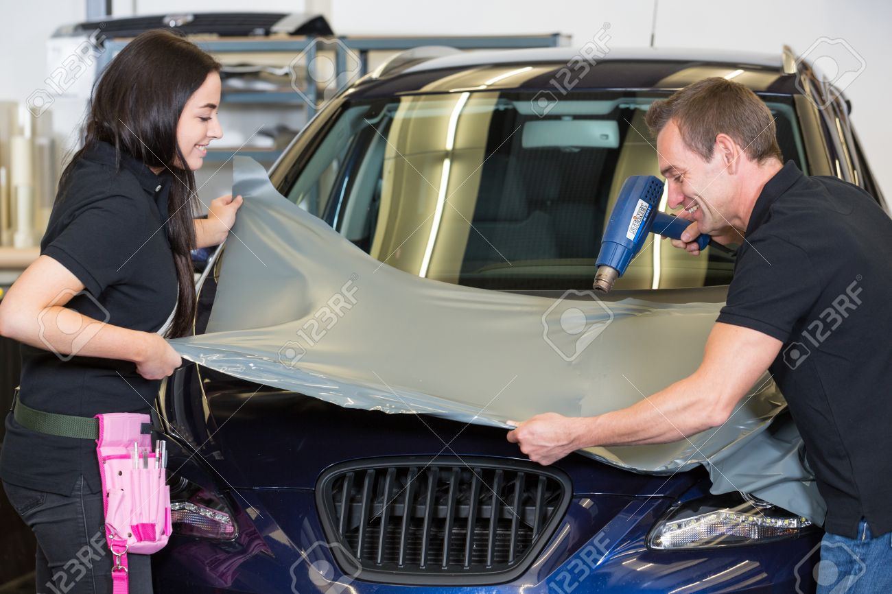 Car Wrapping Specialists Wrapping A Vehicle With Grey Vinyl Film Or Foil Stock Photo Picture And Royalty Free Image Image 28367992