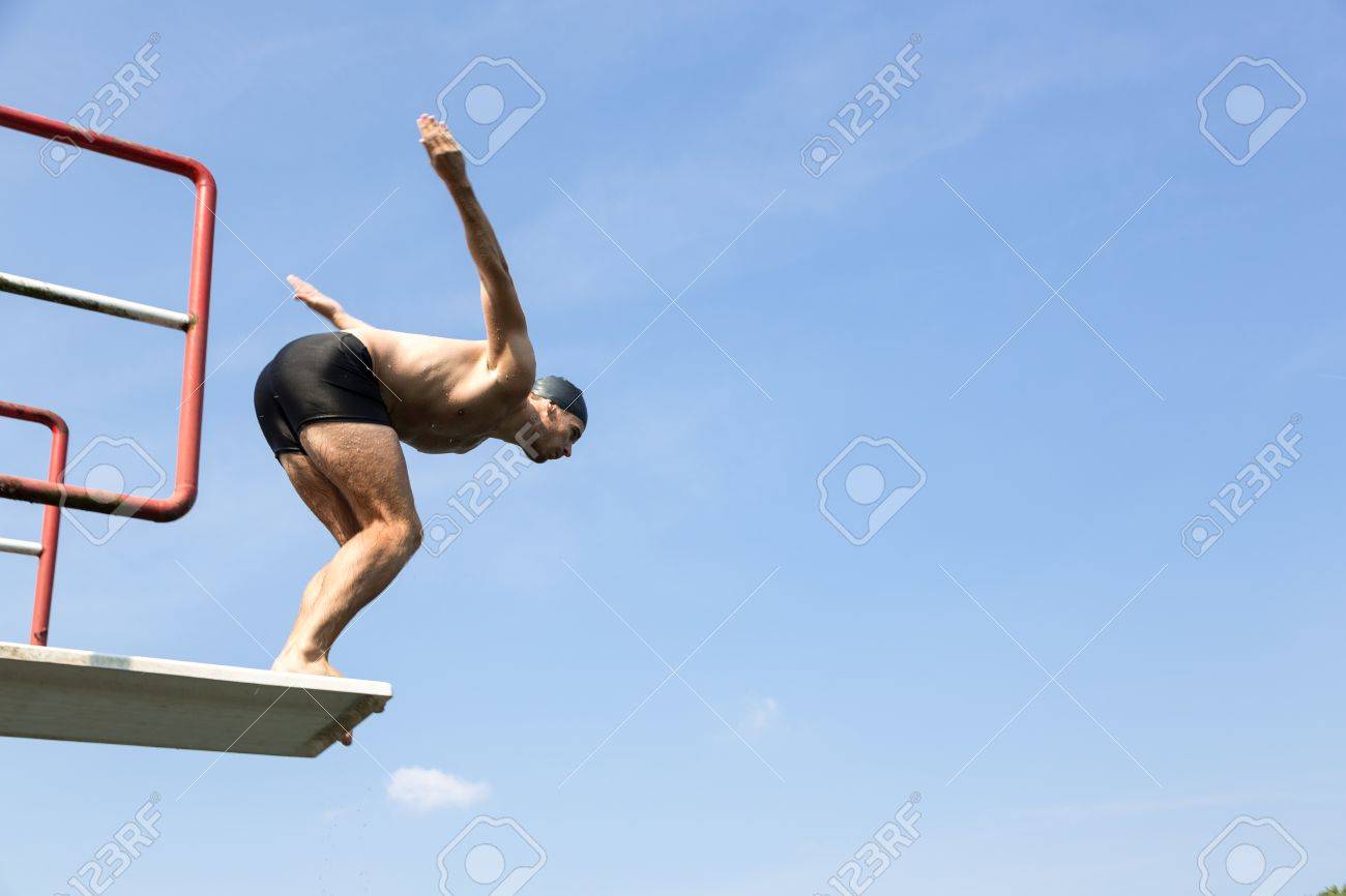 Public Swimming Pools With Diving Boards man jumping off diving board at a public swimming pool stock photo Public Swimming Pools With Diving Boards man jumping off diving board at a public swimming pool stock photo