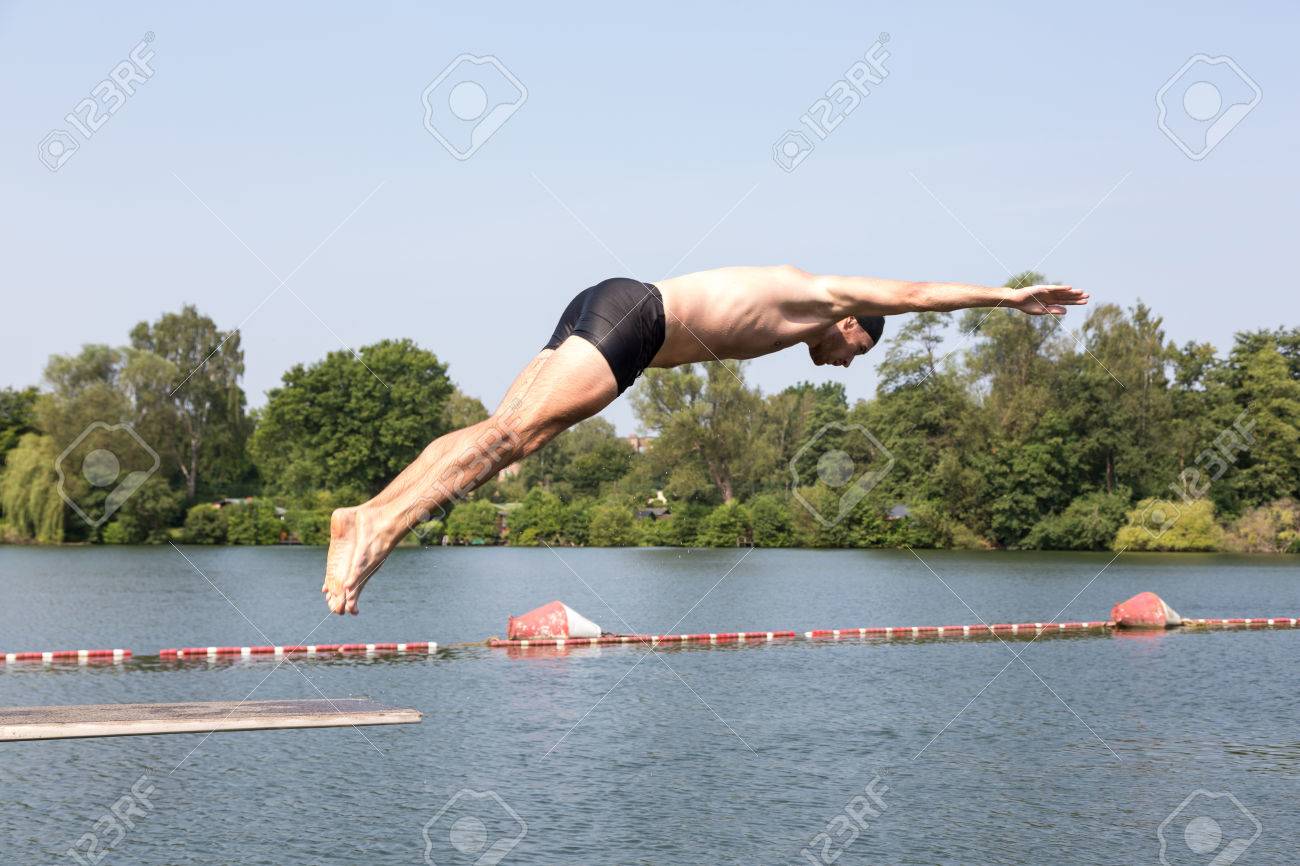 Public Swimming Pools With Diving Boards man jumping off diving board at a public swimming pool stock photo Public Swimming Pools With Diving Boards man jumping off diving board at a public swimming pool stock photo