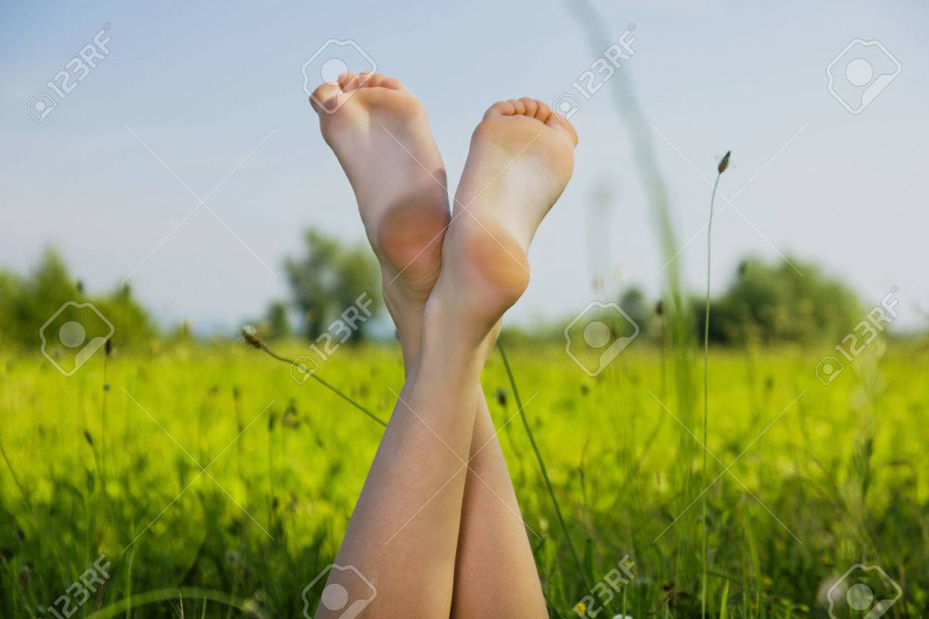 young girl feet Young Girl Chilling In The Grass, With Feet Up Stock Photo, Picture and  Royalty Free Image. Image 37479437.