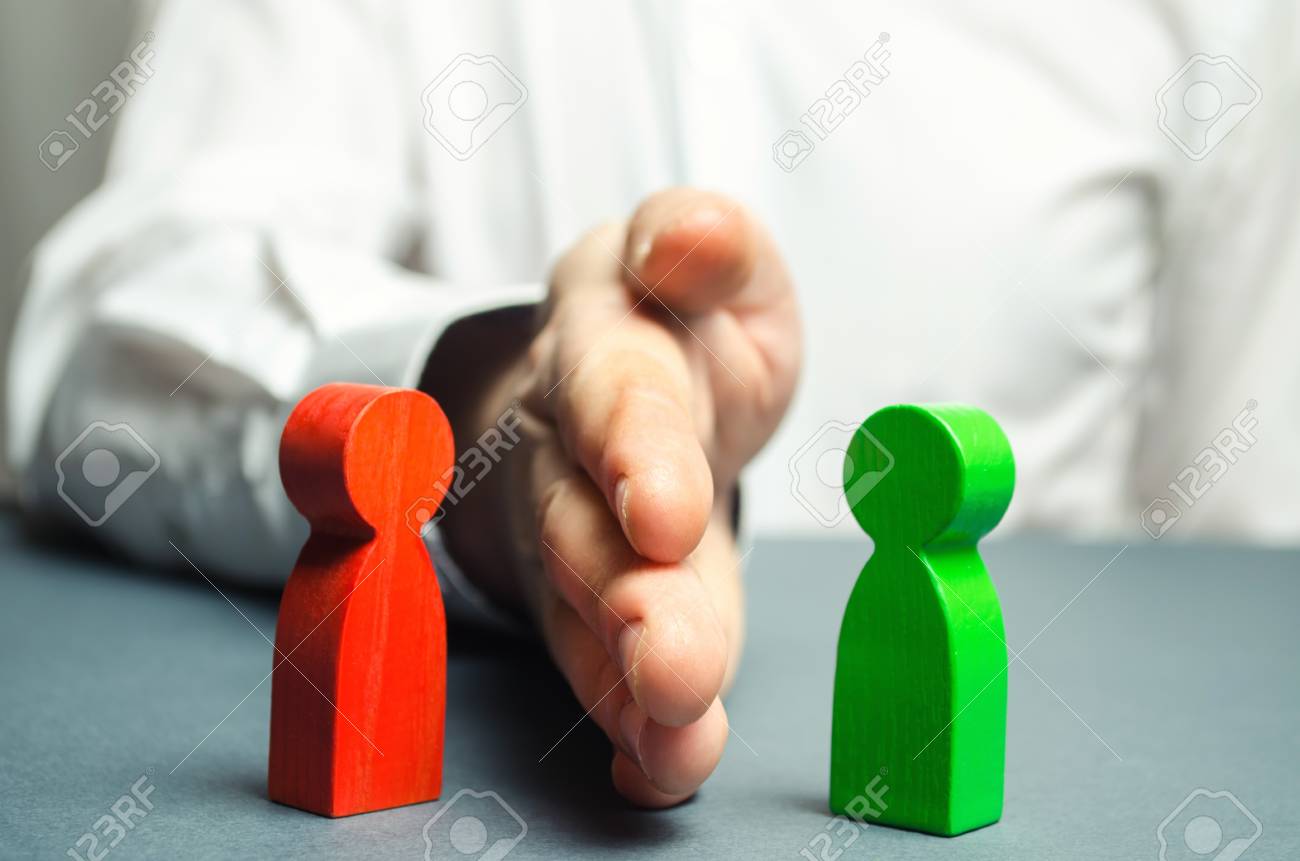 The person divides with the palm the red and green figures of people. Orbiter, the solution of controversial issues and conflicts of interest. Stop the conflict, the mediator. Dispute resolution. - 117670356 The person divides with the palm the red and green figures of people. Orbiter, the solution of controversial issues and conflicts of interest. Stop the conflict, the mediator. Dispute resolution. - 117670356