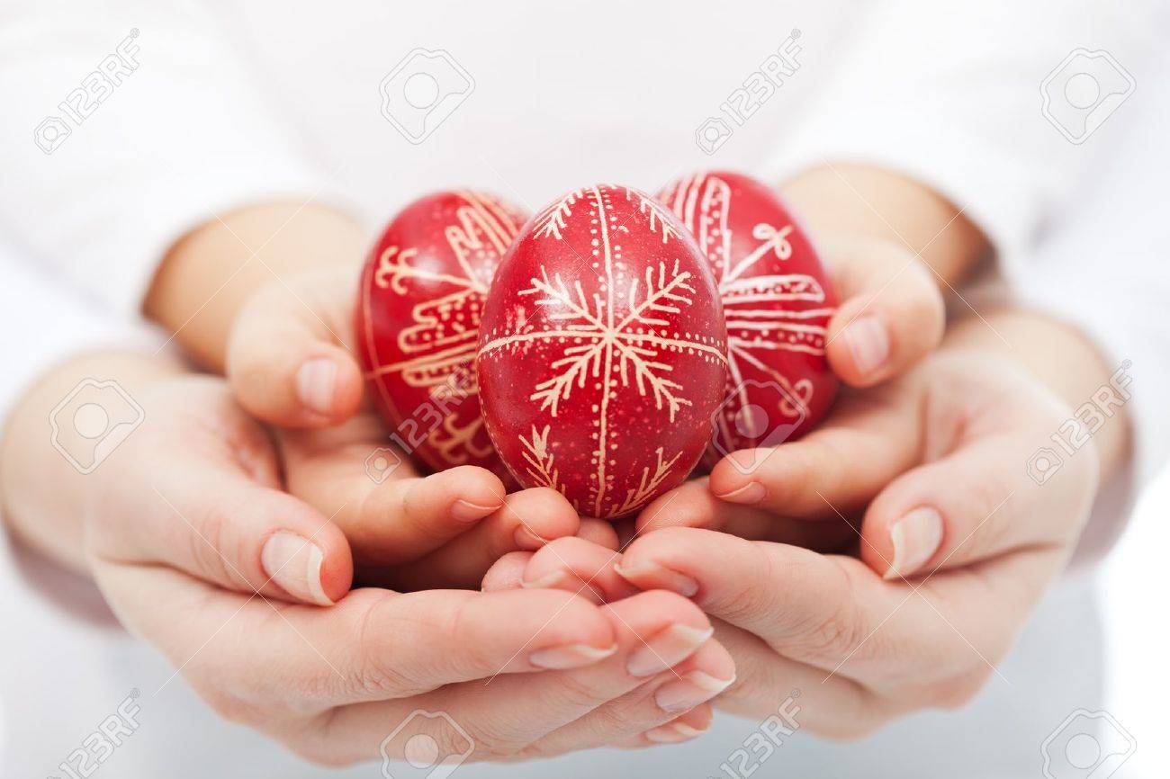 Woman and child hands holding traditional red easter eggs - 18267080 Woman and child hands holding traditional red easter eggs - 18267080